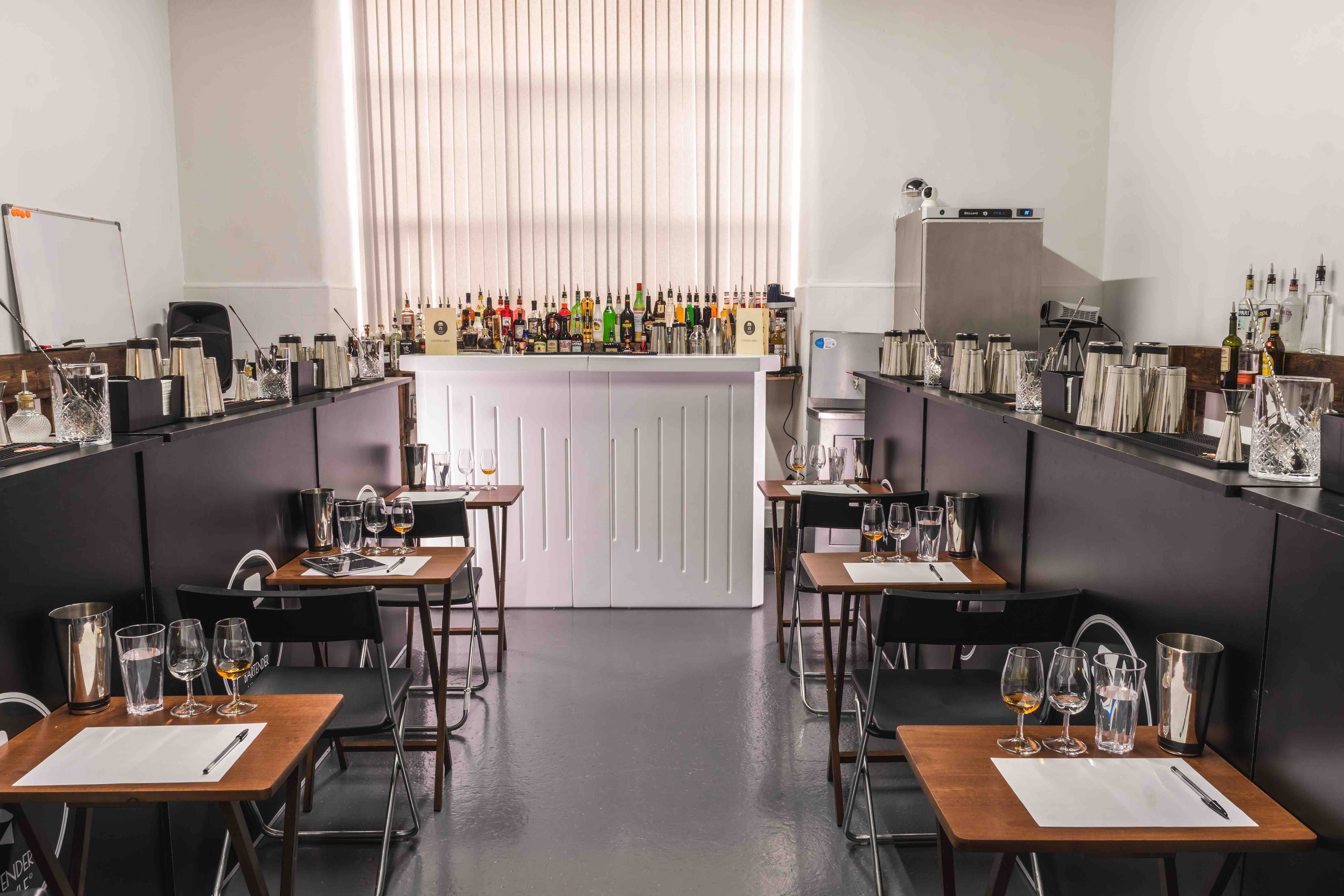 6 tables with set up for the wset lv2 course with glasses and study materials