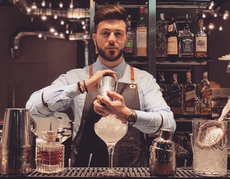 A bartender shaking a cocktail